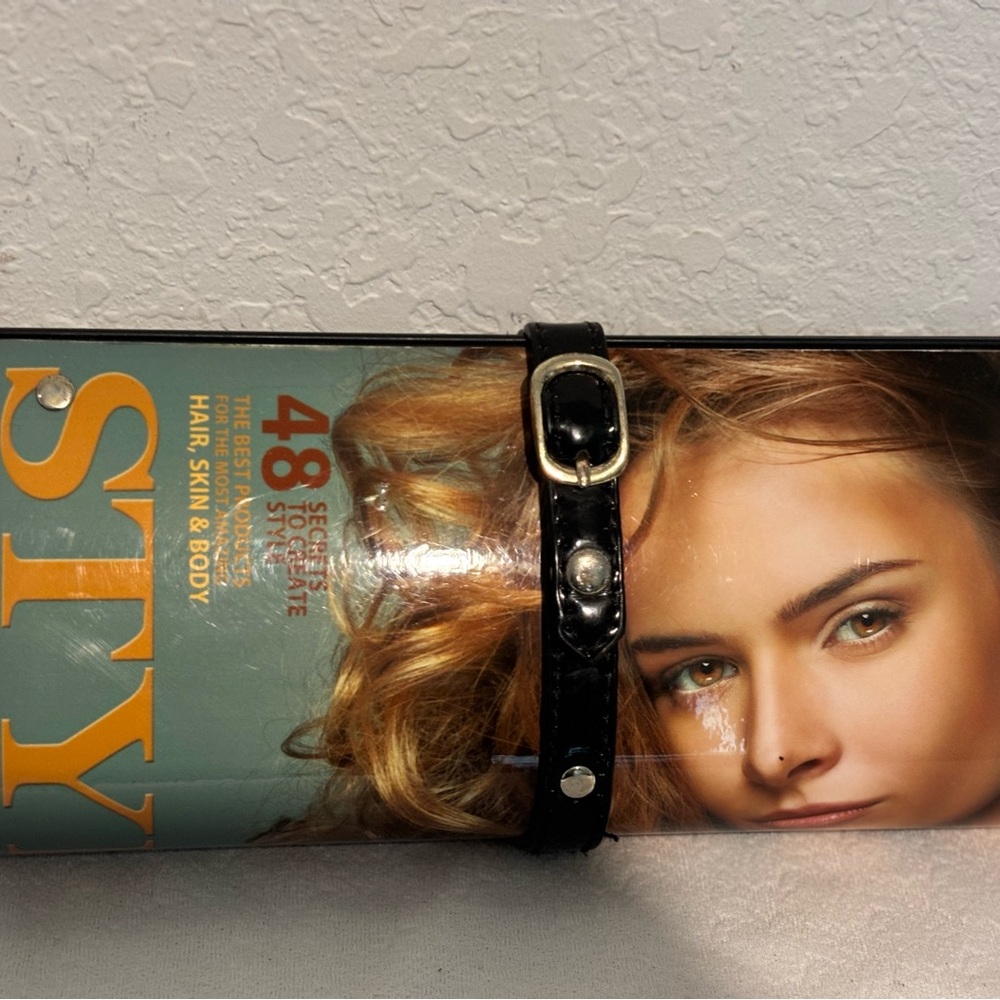 Black womens hand bag with magazine design, hard shell